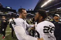 Las Vegas Raiders quarterback Derek Carr (4) celebrates with running back Josh Jacobs (28) after an overtime win over the Seattle Seahawks during an NFL football game Sunday, Nov. 27, 2022, in Seattle. (AP Photo/Caean Couto)