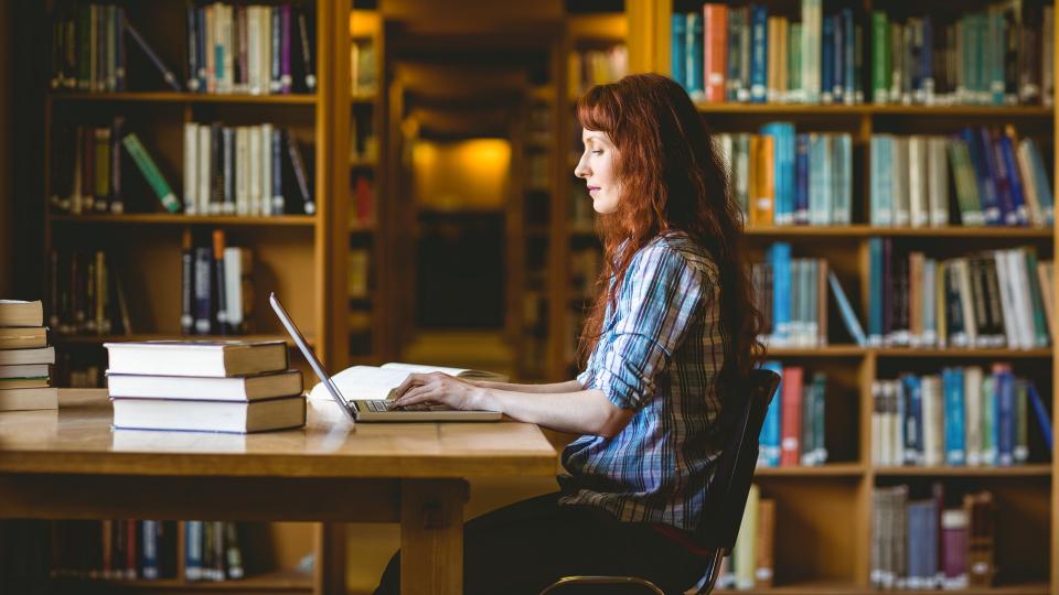 Mature student studying in library at the university.