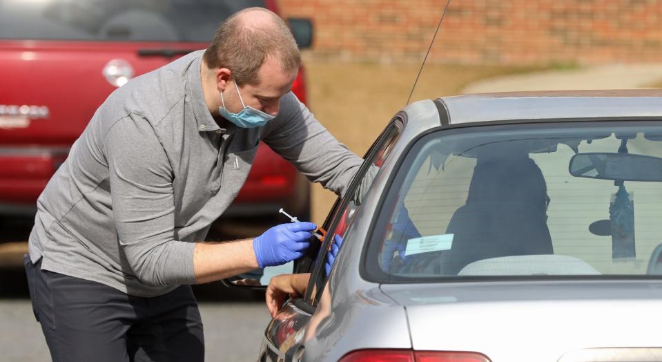 Chris Thrower gives a booster shot to a person Thursday, Jan. 13, 2022, at the Mt. Zion Restoration Church on Crescent Lane in Gastonia.