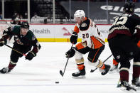 Anaheim Ducks left wing Nicolas Deslauriers (20) carries the puck between Arizona Coyotes defenseman Jordan Oesterle (82) and right wing Christian Fischer (36) during the first period of an NHL hockey game Wednesday, Feb. 24, 2021, in Glendale, Ariz. (AP Photo/Rick Scuteri)