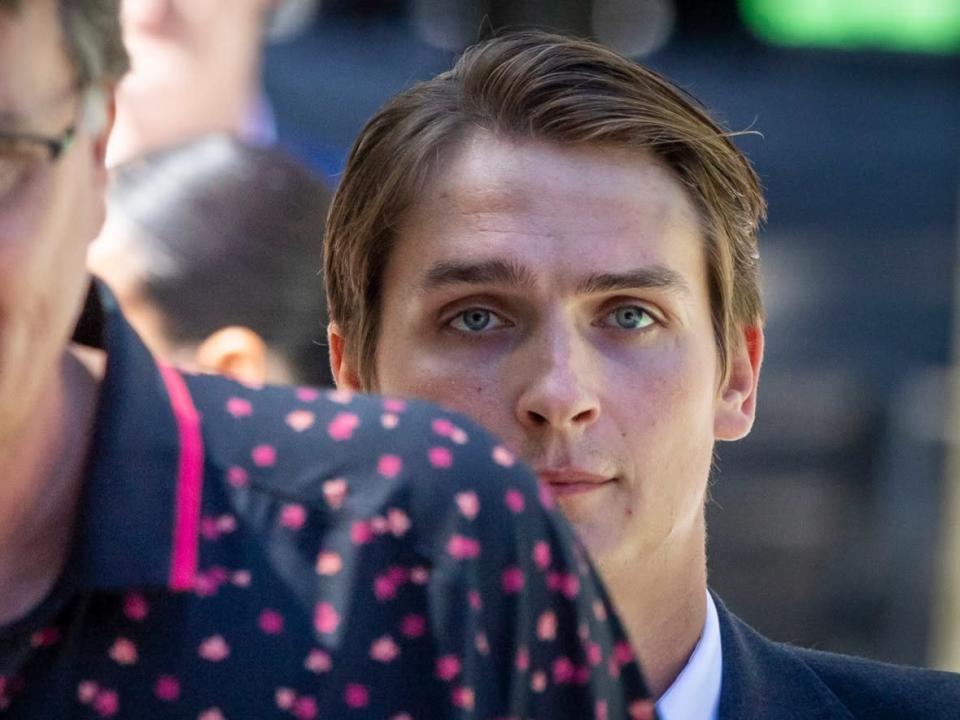 Former Vancouver Canucks hockey player Jake Virtanen walks behind his father Rainer Virtanen during the second day of his trial for sexual assault at the B.C. Supreme Court in Vancouver, B.C. on Tuesday. (Ben Nelms/CBC - image credit)