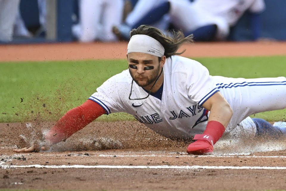 Toronto Blue Jays' Bo Bichette scores on a two-run double by Corey Dickerson during the first inning of a baseball game against the Cleveland Indians on Wednesday, Aug. 4, 2021, in Toronto. (Jon Blacker/The Canadian Press via AP)