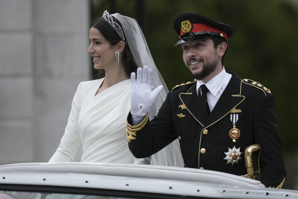 Jordan's Crown Prince Hussein and Saudi Rajwa Alseif wave to well-wishers during their wedding ceremonies in Amman, Jordan, Thursday, June 1, 2023. (AP Photo/Nasser Nasser4