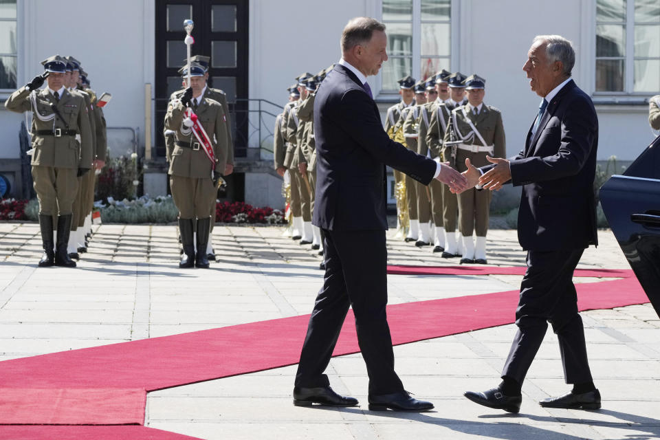 Poland's President Andrzej Duda, left, greets Portuguese President Marcelo Rebelo de Sousa during a state visit at the Belvedere Palace in Warsaw, Poland, Tuesday, Aug. 22, 2023. At a joint news conference de Sousa vowed continuing support for Ukraine's struggle against Russia's invasion, while Duda said Poland is watching Russia's transfer of some nuclear weapons into neighbouring Belarus. (AP Photo/Czarek Sokolowski)