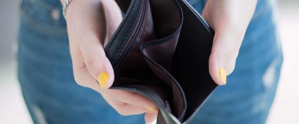 close up of woman showing empty wallet