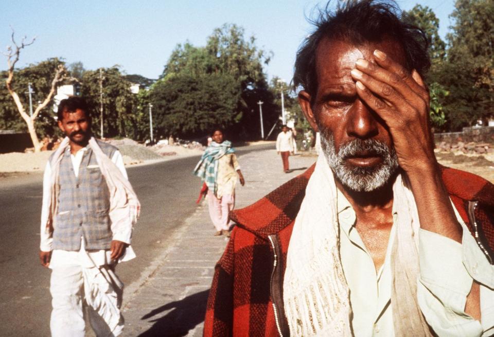 Picture dated 04 December 1984, shows man victim of the Bhopal tragedy. A poison gas leak from the Union Carbide factory killed 2,500 persons and injured around 10,000. On background is the site of the factory.
