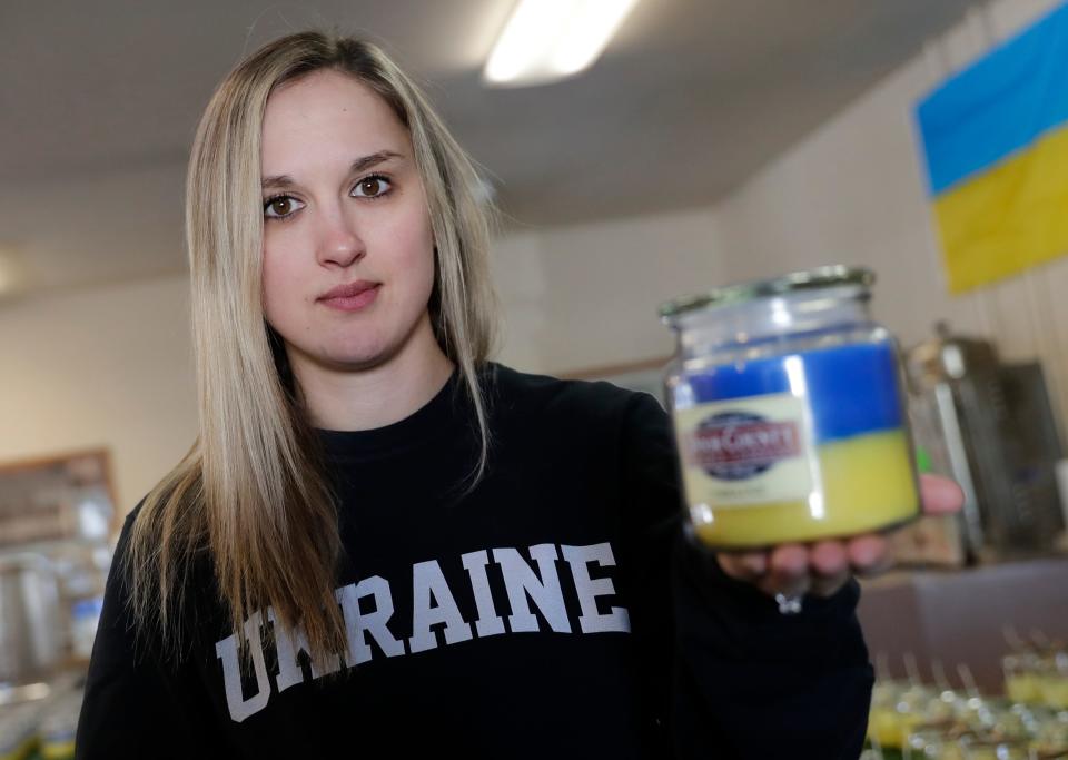 Christiana Gorchynsky Trapani, owner of Door County Candle Co., is shown with one of the Ukraine Candles her company is selling to raise funds for humanitarian aid in Ukraine. Profits from the candles are being donated to Razom for Ukraine.