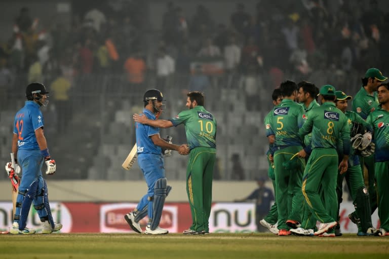 Pakistan's captain Shahid Afridi (C-R) congratulates India's captain Mahendra Singh Dhoni (C-L) at the end of the Asia Cup T20 cricket tournament match between India and Pakistan at the Sher-e-Bangla National Cricket Stadium in Dhaka on February 27, 2016