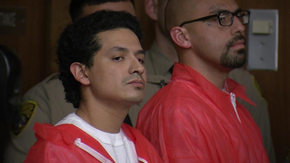 Anthony Rivera, left, and Andrew Jimenez listen while being arraigned on charges including murder.