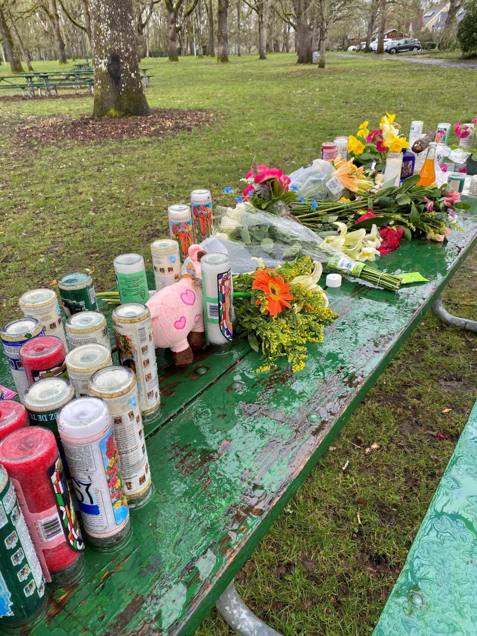 A picnic table at Bush's Pasture Park in Salem is covered with candles and flowers following the fatal shooting of South Salem High School students. Two other teens also were shot and hospitalized.