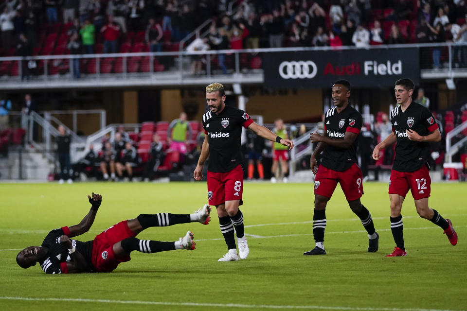 D.C. United forward Nigel Robertha, left, celebrates his goal during the second half of an MLS soccer match against the New England Revolution, Wednesday, Oct. 20, 2021, in Washington. The Revolution won 3-2. (AP Photo/Alex Brandon)