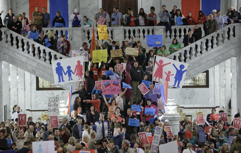 Protesters are shown during a rally for the opponents for gay marriage at the Utah State Capitol Tuesday, Jan. 28, 2014, in Salt Lake City. Opponents and supporters of gay marriage held twin rallies at the Utah State Capitol on Tuesday evening. The opposing gatherings are the latest square-off over gay marriage, an issue that took Utah by surprise over the past month. More than 1,000 gay couples rushed to wed when a federal judge overturned Utah's constitutional amendment banning same-sex marriage in late December. Voters approved the amendment in 2004. Same-sex marriages continued in Utah until early January, when the U.S. Supreme Court granted Utah's request for an emergency halt to the weddings. (AP Photo/Rick Bowmer)