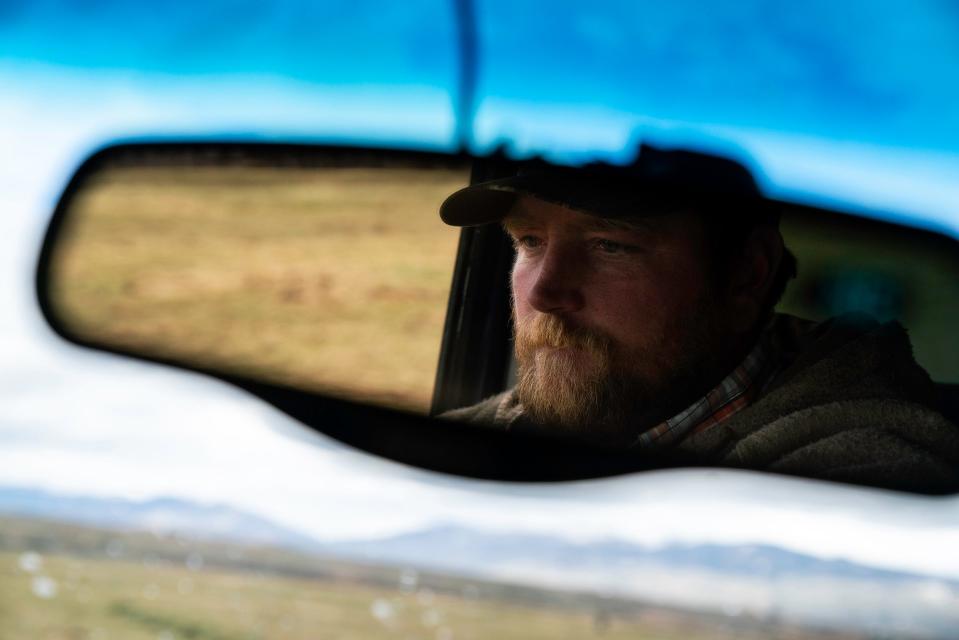 Conway Farrell is shown in his review mirror while checking on his cattle on his ranch near Kremmling in Grand County on April 28.