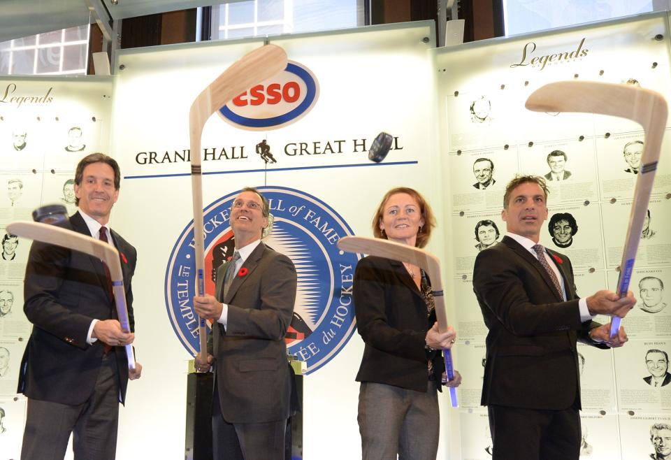 From left to right, new inductees Brendan Shanahan, Scott Niedermayer, Geraldine Heaney and Chris Chelios juggle pucks on sticks at the Hockey Hall of Fame in Toronto.