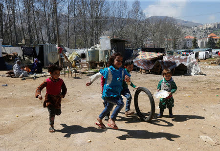 Syrian refugee children run in a tented settlement, in the town of Qab Elias, in Lebanon's Bekaa Valley, March 13, 2018. REUTERS/Mohamed Azakir