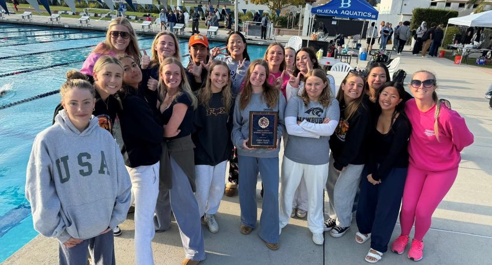 The Newbury Park High girls swimming team poses with the championship plaque after winning the team title at the 15th annual Ventura County Swimming Championships at Buena High.