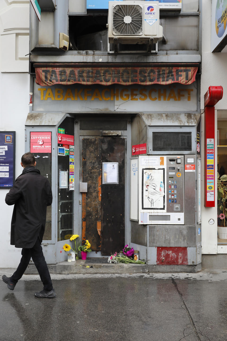 The entrance of the tobacco shop belonging to a woman who was covered on gasoline and lit on fire by her former partner Vienna, Austria, Friday, May 14, 2021. Austria is one of the few European Union countries where the number of women killed is higher than the number of men. The recent high-profile cases have led to widespread protests, demands for government intervention and condemnations from top politicians. (AP Photo/Lisa Leutner)