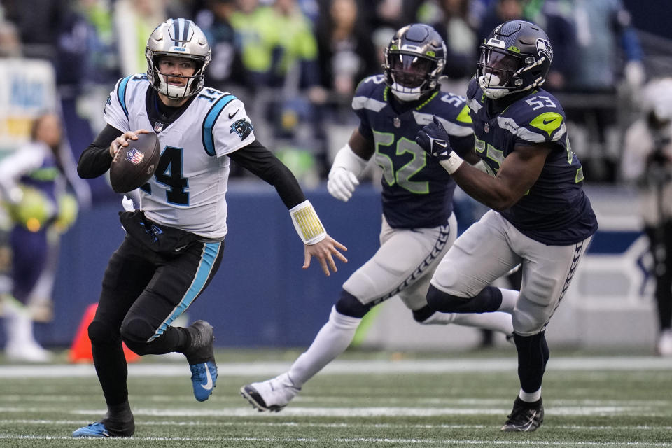 Carolina Panthers quarterback Sam Darnold (14) runs down field against the Seattle Seahawks during the second half of an NFL football game, Sunday, Dec. 11, 2022, in Seattle. (AP Photo/Gregory Bull)