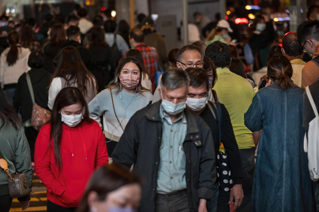 HONG Omicron’s spread across quarantine hotel hallway in Hong Kong highlights transmission worry. (PHOTO: Miguel Candela/SOPA Images/LightRocket via Getty Images), CHINA - 2021/12/02: A large crowd of people is seen wearing face masks as a preventive measure against the spread of coronavirus as they walk through a zebra crossing in Hong Kong. The city of Hong Kong is on high alert as a heavily-mutated new Covid-19 variant known as the Omicron variant has been detected from a passenger traveling from South Africa. (Photo by Miguel Candela/SOPA Images/LightRocket via Getty Images)