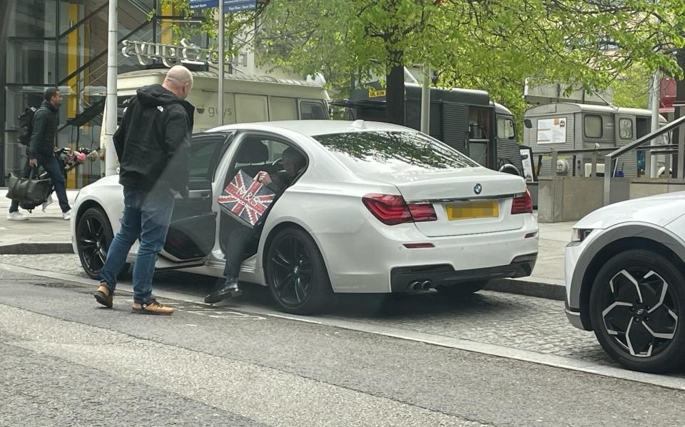 Nigel Farage was seen into his car by a chauffeur as he clutched an M&S shopping bag