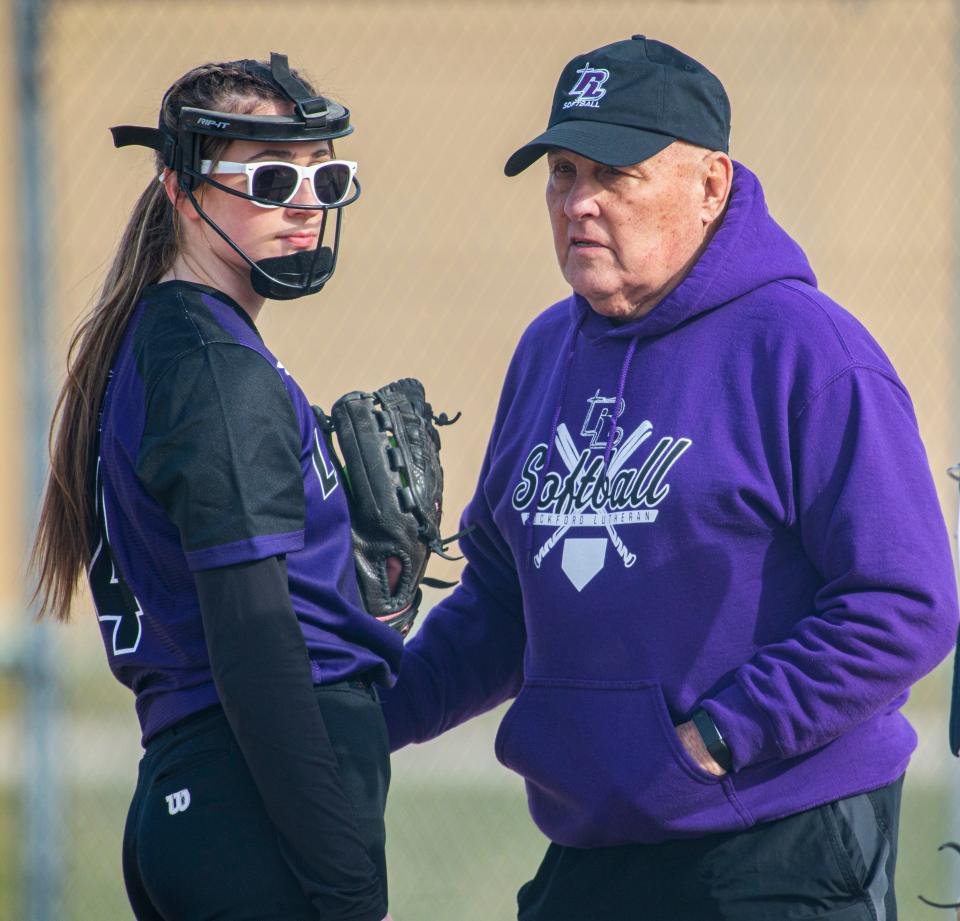 Lutheran's coach Joe Lodico speaks to pitcher Sami Spangler on Tuesday, April 19, 2022, at North Boone High School in Popular Grove.