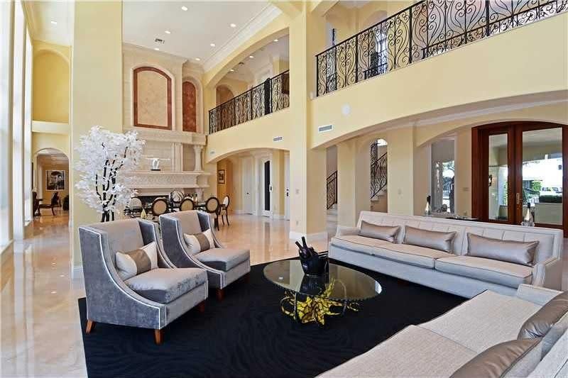 <p>The room’s centrepieces, however, are its two-storey fireplace and floor-to-ceiling windows. (Realtor.com) </p>