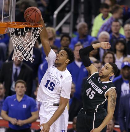 Duke's Jahlil Okafor (15) dunks the ball ahead of Michigan State's Denzel Valentine during the second half. (AP)