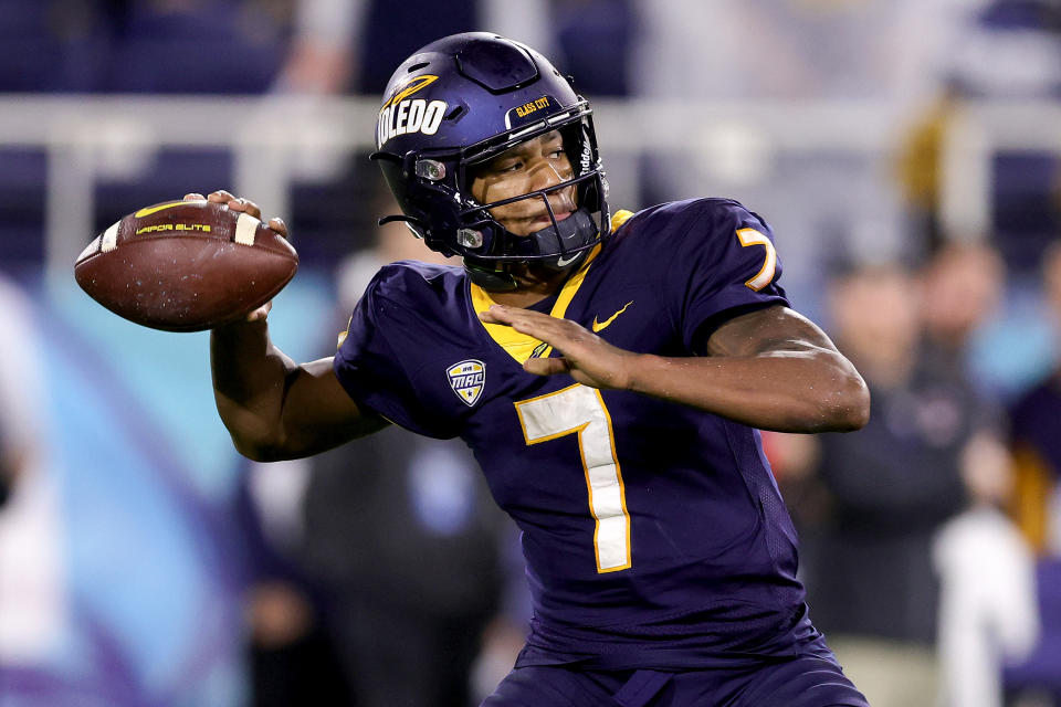 BOCA RATON, FLORIDA - DECEMBER 20: Dequan Finn #7 of the Toledo Rockets throws a pass against the Liberty Flames during the first half of the game during the RoofClaim.com Boca Raton Bowl at FAU Stadium on December 20, 2022 in Boca Raton, Florida. (Photo by Megan Briggs/Getty Images)