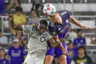 CF Montreal's Sunusi Ibrahim, left, and Orlando City's Robin Jansson go up to try to get advantage on a head ball during the second half of an MLS soccer match, Wednesday, Oct. 20, 2021, in Orlando, Fla. (AP Photo/John Raoux)