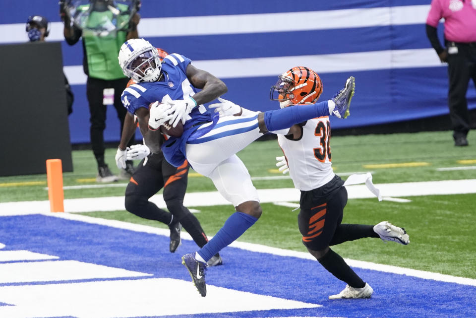 Indianapolis Colts' Zach Pascal (14) makes a touchdown reception against Cincinnati Bengals' LeShaun Sims (38) during the first half of an NFL football game, Sunday, Oct. 18, 2020, in Indianapolis. (AP Photo/AJ Mast)