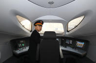 The train driver of the high speed train that runs on the new 2,298-kilometre (1,425-mile) line between Beijing and Guangzhou takes a rest in Zhengzhou train station in Zhengzhou, central China's Henan province on December 26, 2012. China started service on December 26 on the world's longest high-speed rail route, the latest milestone in the country's rapid and -- sometimes troubled -- super fast rail network. The opening of this new line means passengers will be whisked from the capital to the southern commercial hub in just eight hours, compared with the 22 hours previously required. CHINA OUT AFP PHOTO