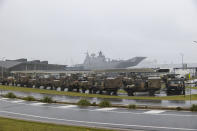 In this photo provided by the Australian Defence Force, vehicles are parked at the Port of Brisbane ready to be loaded onto HMAS Adelaide at the Port of Brisbane before departing for Tonga Thursday, Jan. 20, 2022, after a volcano eruption. U.N. humanitarian officials report that about 84,000 people — more than 80% of Tonga's population — have been impacted by the volcano's eruption. (Cpl. Robert Whitmore/Australia Defence Force via AP)