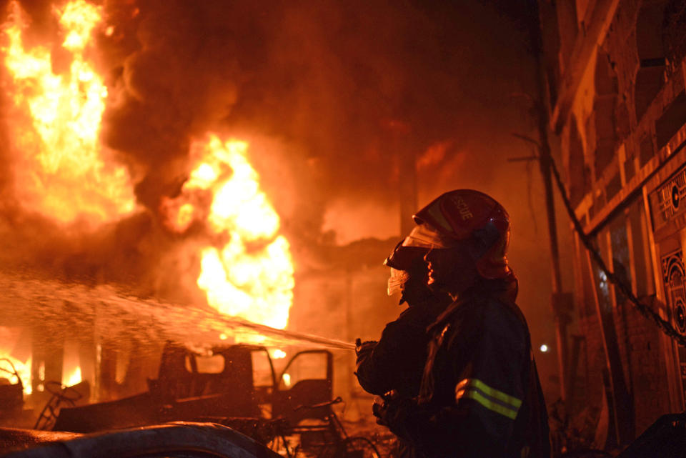 Firefighters try to douse a fire in Dhaka, Bangladesh, Feb. 20, 2019. A devastating fire raced through at least five buildings in an old part of Bangladesh's capital and killed scores of people. (Photo: AP)