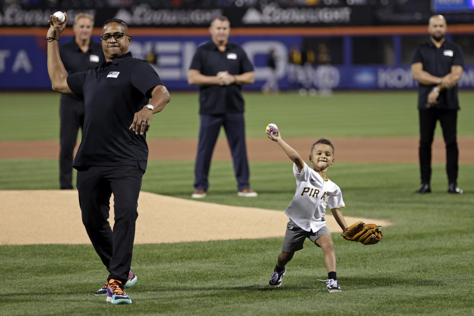 Roberto Clemente Jr. and Roberto Clemente III throw first pitches before a baseball game between the Pittsburgh Pirates and the New York Mets on Thursday, Sept. 15, 2022, in New York. (AP Photo/Adam Hunger)