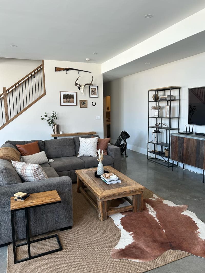 Room with layered rugs on concrete floor