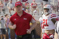 Nebraska head coach Scott Frost runs onto the field before an NCAA college football game against Oklahoma, Saturday, Sept. 18, 2021, in Norman, Okla. (AP Photo/Sue Ogrocki)