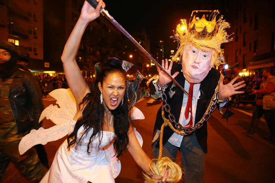 <p>Marni Halasa brandishes a sword in front of a man in a Donald Trump costume with a sword at the 44th annual Village Halloween Parade in New York City on Oct. 31, 2017. (Photo: Gordon Donovan/Yahoo News) </p>