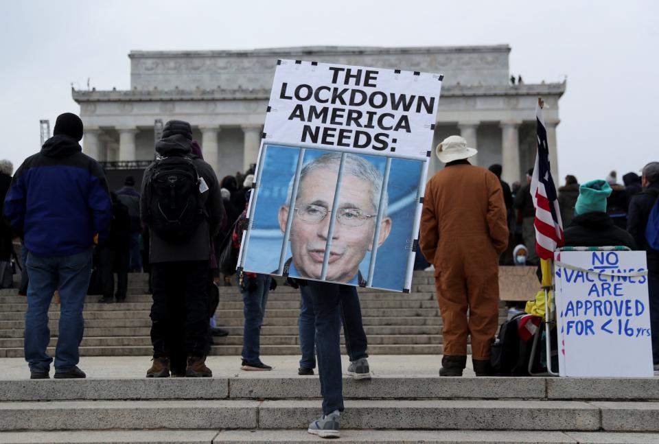 A person holds a placard outside the Lincoln Memorial during a march in opposition to Covid-19 vaccine mandates (REUTERS)