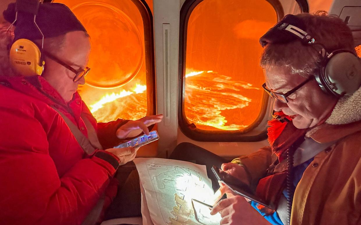 Seen from an Icelandic Coast Guard helicopter, smoke and flowing lava from a new fissure during a surveillance flight near the evacuated town of Grindavik, western Iceland