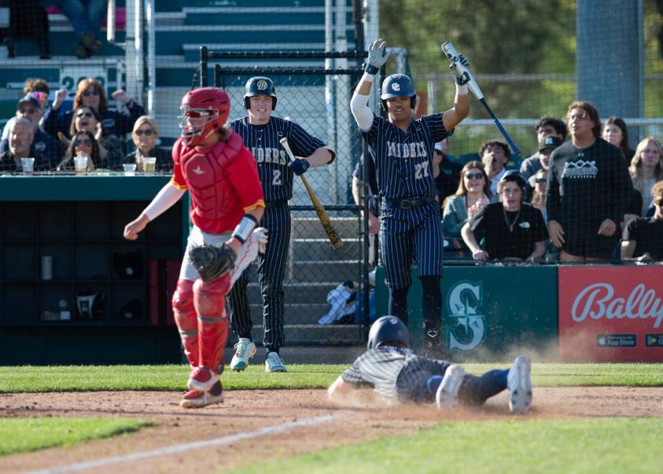 Central Catholic’s TP Wentworth slides home safely during the Valley Oak League showcase game with Oakdale at John Thurman Field in Modesto, Calif., Friday, March 31, 2023. Oakdale won the game 10-6.