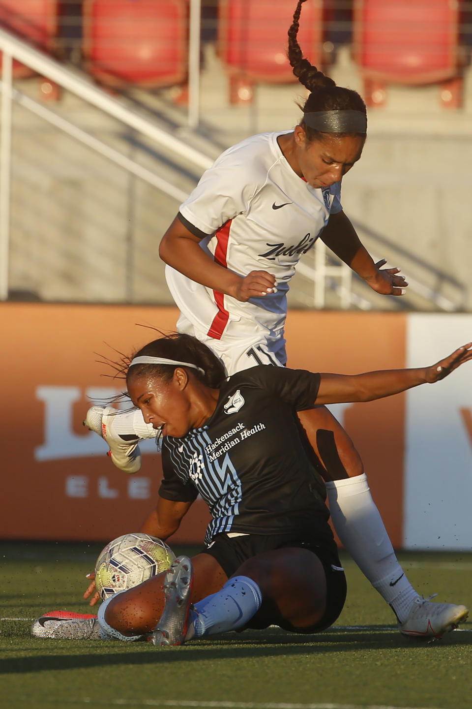 Sky Blue FC forward Midge Purce, foreground, works for the ball against OL Reign forward Darian Jenkins (11) during the first half of an NWSL Challenge Cup soccer match at Zions Bank Stadium on Tuesday, June 30, 2020, in Herriman, Utah. (AP Photo/Rick Bowmer)