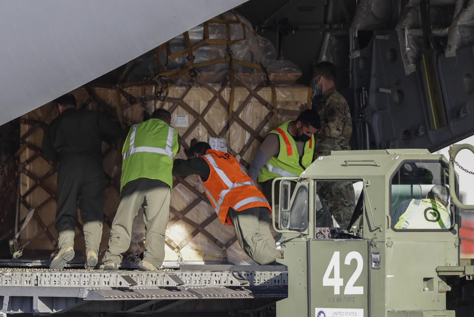 Ground crew load cargo onto a U.S. Air Force C-17 as they prepare to take the season's first flight to McMurdo Station in Antarctica from Christchurch Airport, New Zealand, Monday, Sept. 14, 2020. The first U.S. flight into Antarctica following months of winter darkness left from New Zealand Monday with crews extra vigilant about keeping out the coronavirus. (AP Photo/Mark Baker)