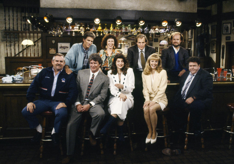 CHEERS — ‘One for the Road’ Episode 25 — Aired 5/20/93 — Pictured: (Back row l-r) Ted Danson as Sam Malone, Rhea Perlman as Carla Tortelli, Woody Harrelson as Woody Boyd, Kelsey Grammer as Dr. Frasier Crane (front row l-r) John Ratzenberger as Cliff Clavin, Tom Berenger as Don Santry, Kirsty Alley as Rebecca Howe, Shelley Long as Diane Chambers, George Wendt as Norm Peterson (Getty Images)