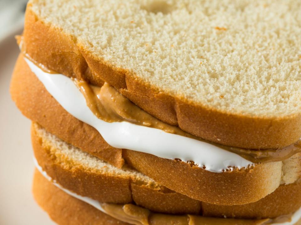 fluffernutter sandwiches piled on top of a plate