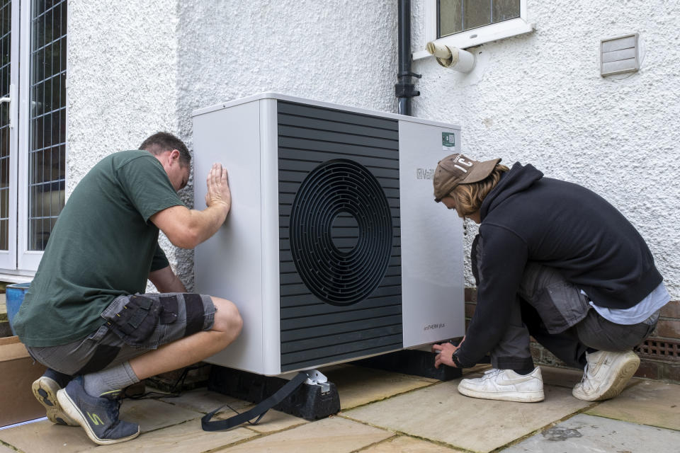 Air source heat pump installers from Solaris Energy installing a Vaillant Arotherm plus 7kw air source heat pump unit into a 1930s built house in Folkestone, United Kingdom on the 20th of September 2021.  With gas prices increasing and the increasing need to reduce fossil fuel air source heat pumps are slowly starting to replace the gas boiler use in properties in the UK. (photo by Andrew Aitchison / In pictures via Getty Images)