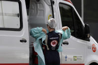 A doctor prepares to transport a patient suspected of having COVID-19 into the HRAN public hospital from an ambulance in Brasilia, Brazil, Wednesday, April 14, 2021.(AP Photo/Eraldo Peres)