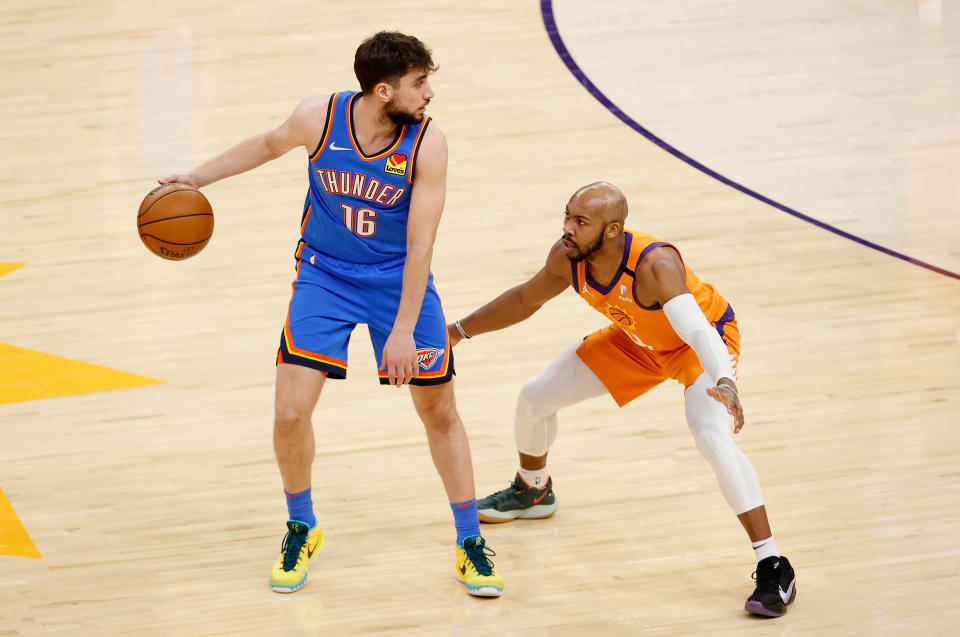 PHOENIX, ARIZONA - APRIL 02: Ty Jerome #16 of the Oklahoma City Thunder handles the ball against Jevon Carter #4 of the Phoenix Suns during the NBA game at Phoenix Suns Arena on April 02, 2021 in Phoenix, Arizona. The Suns defeated the Thunder 140-103. NOTE TO USER: User expressly acknowledges and agrees that, by downloading and or using this photograph, User is consenting to the terms and conditions of the Getty Images License Agreement. 