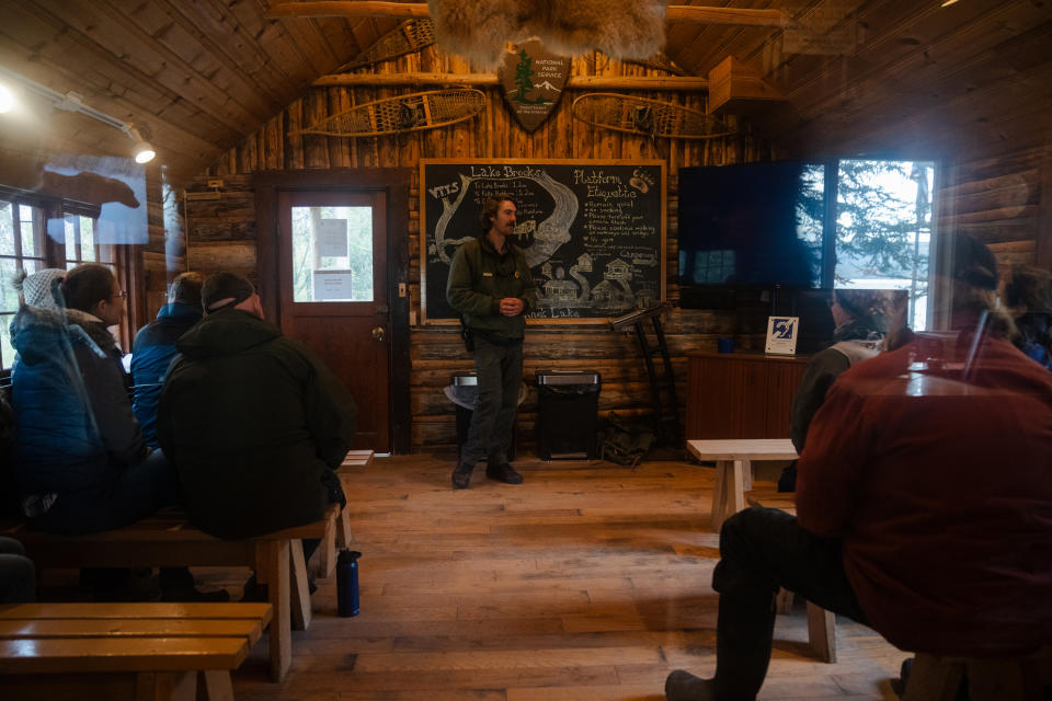 Lead interpretive ranger Keith Moore gives a bear orientation to visitors in the Brooks Camp visitor center. (Photo for The Washington Post by Sophie Park)