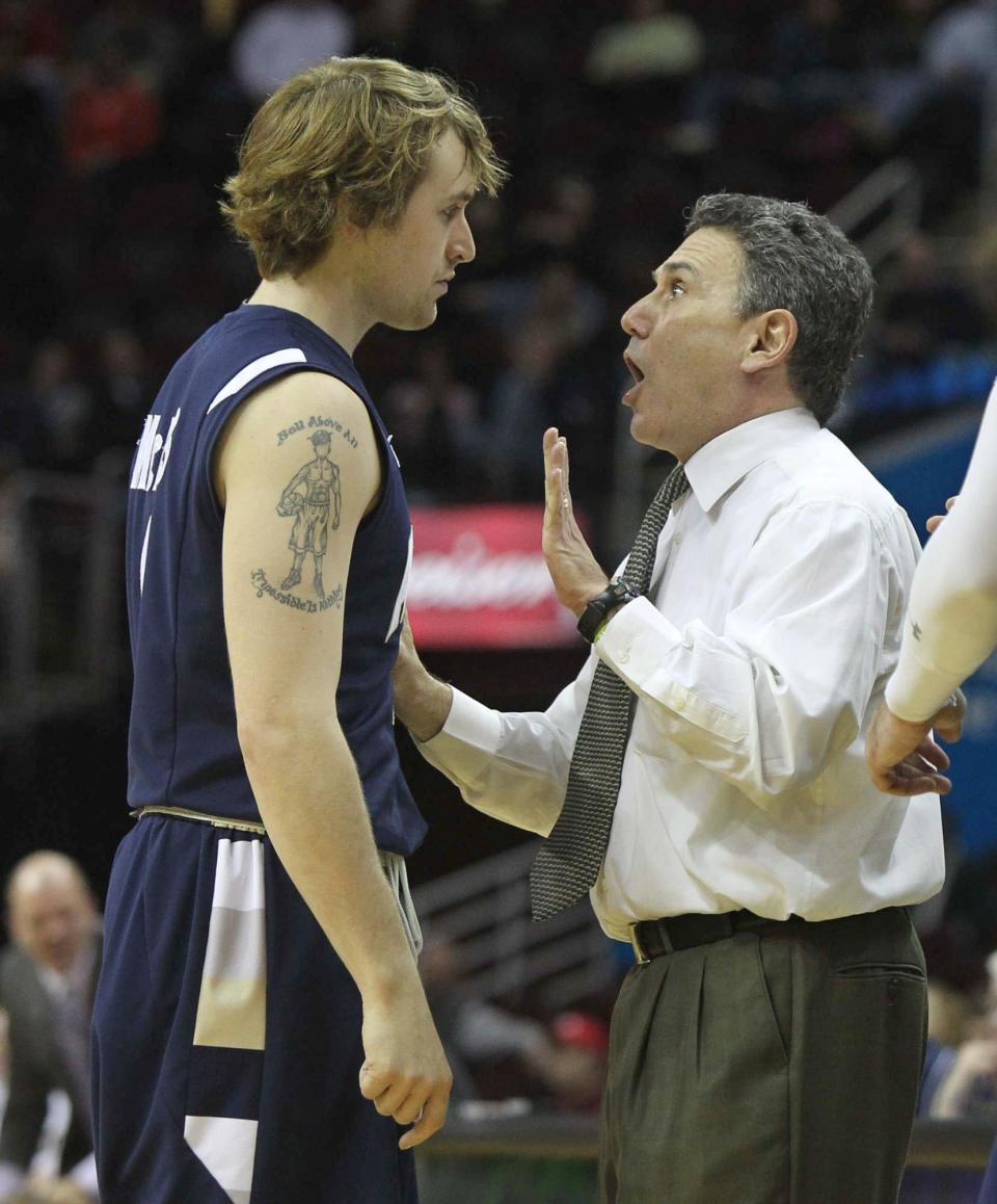 University of Akron's Steve McNees (left) gets a few words from head coach Keith Dambrot during the second half against Western Michigan in a MAC tournament semifinal, Friday, March 11, 2011, in Cleveland.