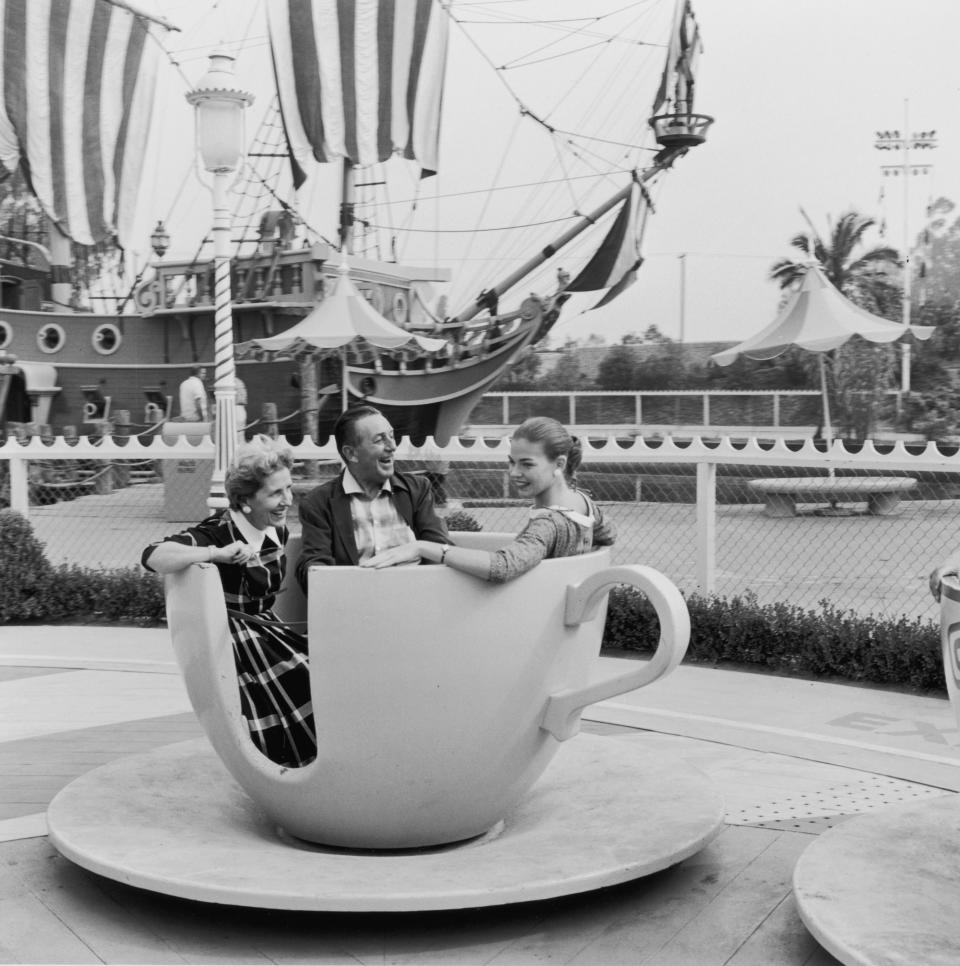 Disney rides a spinning teacup with his wife, Lillian, and their daughter, Diane, shortly after Disneyland's opening.